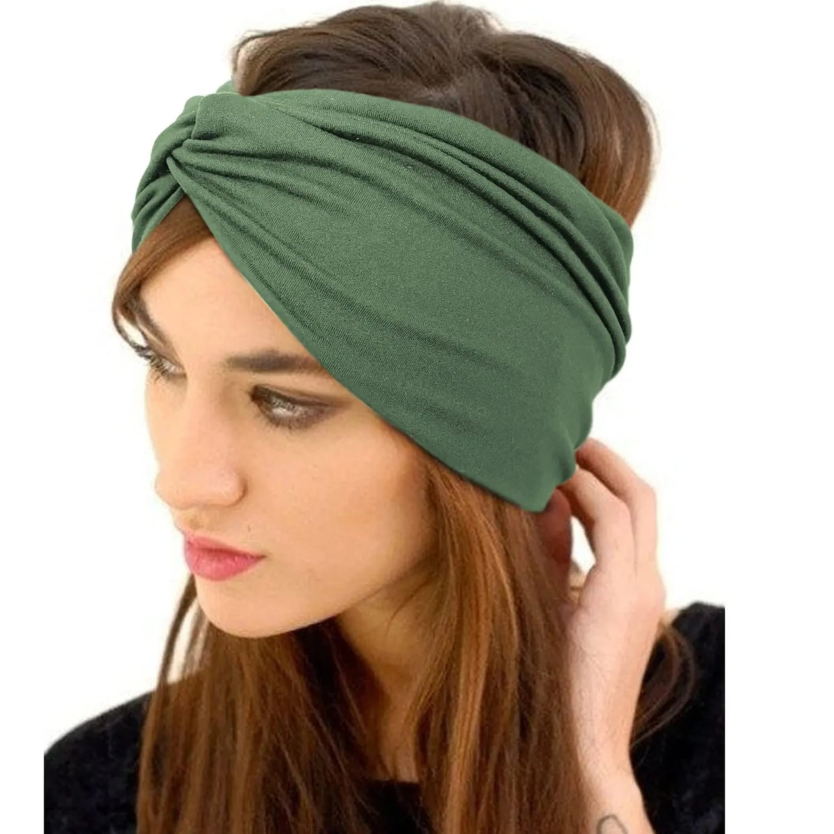 A woman wearing a dark olive green boho wide turban headband on her hair.
