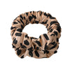A beige and black animal print heatless curling rod headband made of gathered fabric.