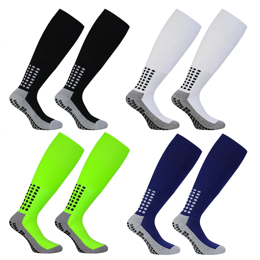 A set of professional training football socks in black, white, lime green, and navy blue colors.