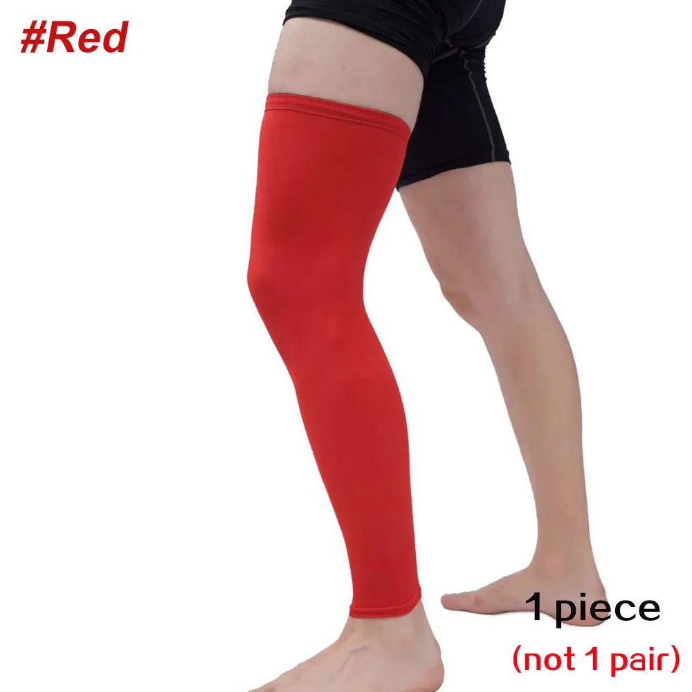 A full leg compression sleeve in red worn on a person's leg.
