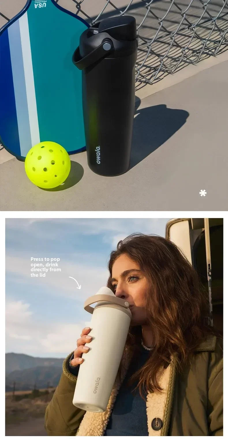 A woman holds an Owala insulated stainless steel travel mug outdoors.