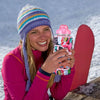 A smiling woman wearing a purple knitted hat and pink jacket holds an insulated water bottle cover.