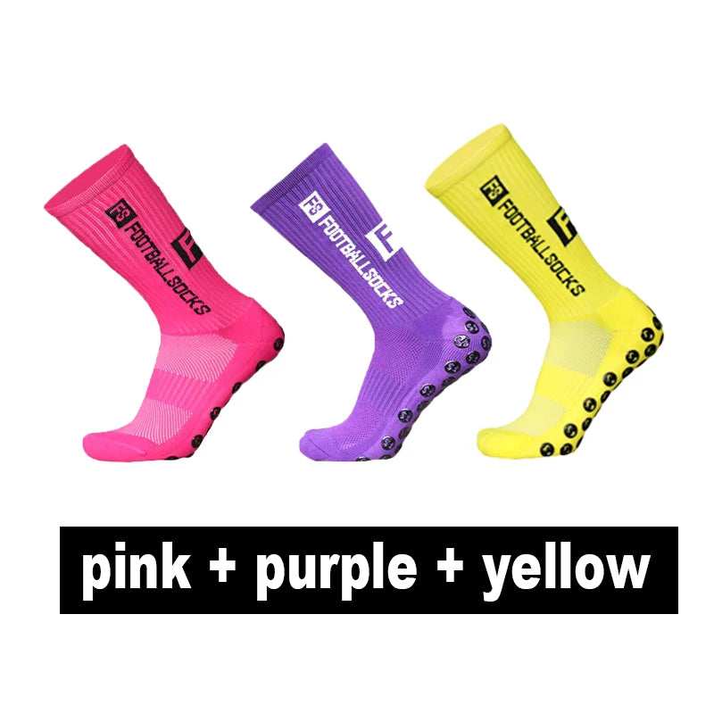 A set of three anti-slip silicone grip football socks in pink, purple, and yellow.