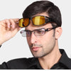 A man wearing black sunglasses with yellow lenses and a dark shirt.