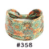 Boho knotted cotton headband in a floral pattern featuring teal, orange, and green tones.