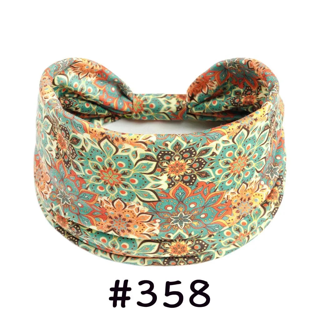 Boho knotted cotton headband in a floral pattern featuring teal, orange, and green tones.