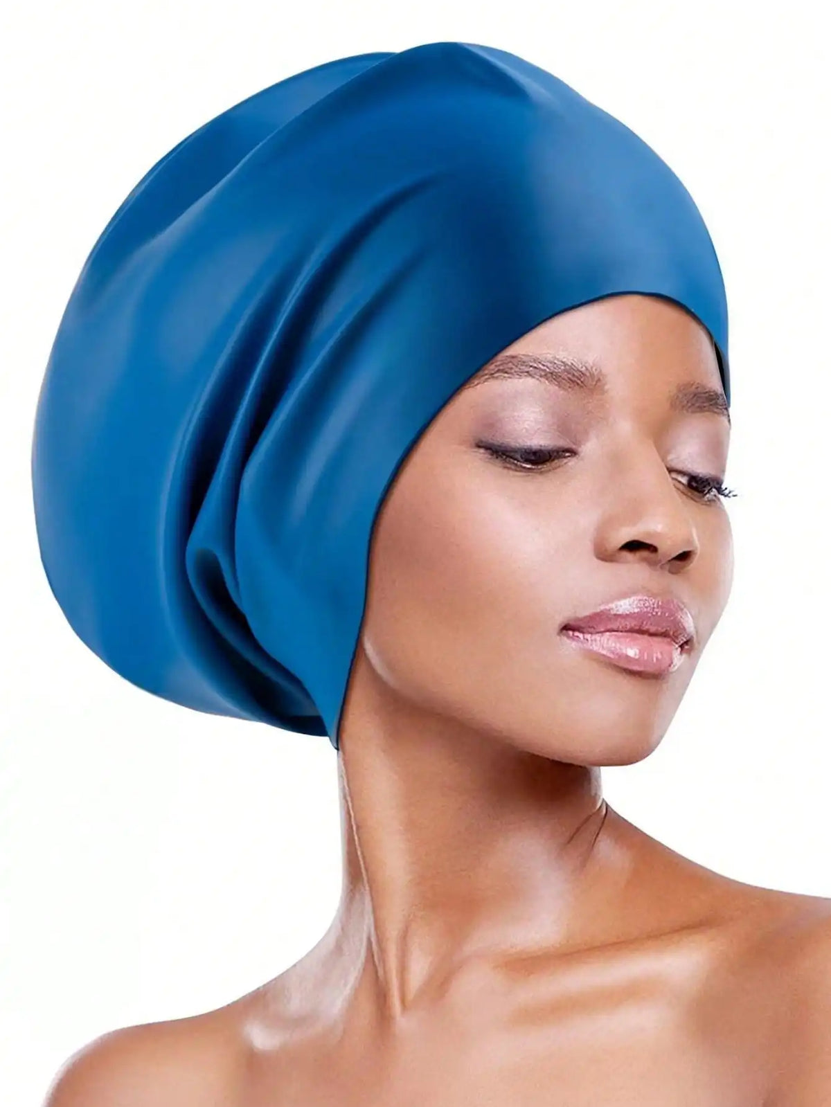A close-up of a woman wearing a royal blue silicone swim cap for long hair.