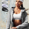 A woman is shown wearing a gray hoodie and jeans, with several white sports headbands displayed above her head.
