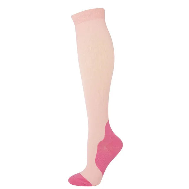 A single pair of light pink compression socks shown standing upright.