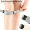 A close-up of a gray knee support strap being applied to a person's leg.