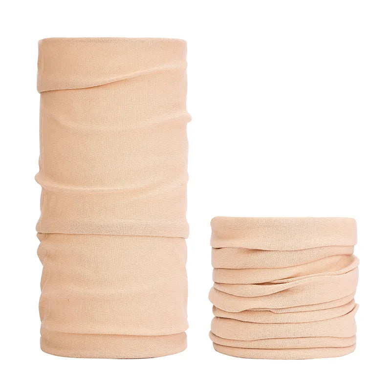 A stack of beige seamless fabric headbands and balaclavas.