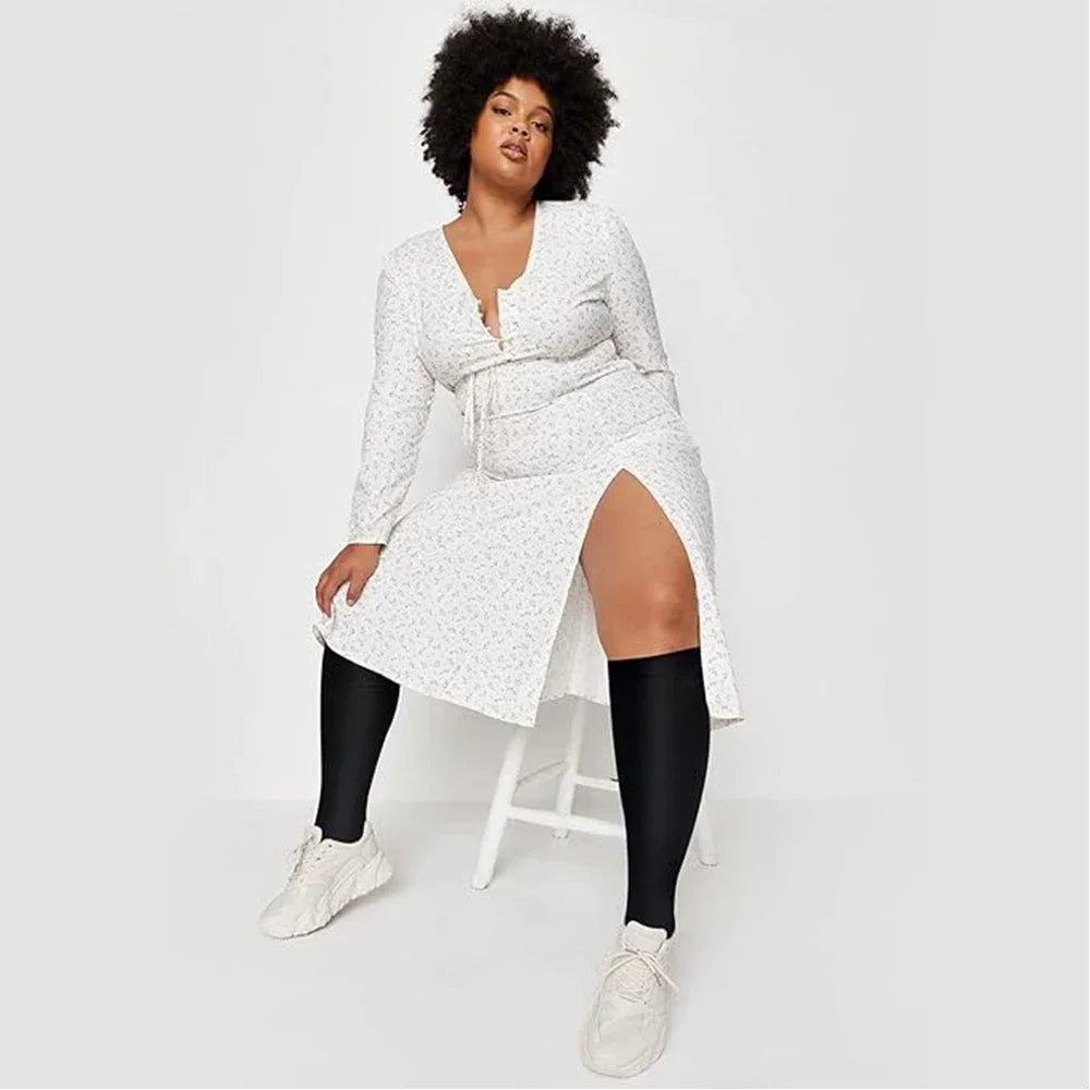A woman models white patterned compression socks and a matching dress.