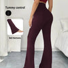 A model wears dark burgundy high-waisted yoga leggings with flare details, demonstrating tummy control.