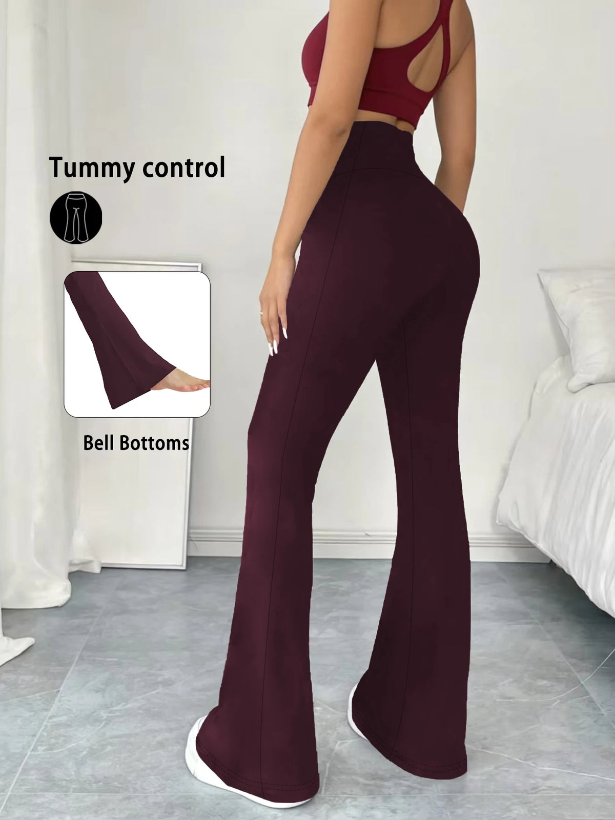 A model wears dark burgundy high-waisted yoga leggings with flare details, demonstrating tummy control.