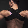 A person wearing a black elastic yoga and fitness support belt on their back.