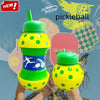 A hand holds a bright yellow and green silicone sports water bottle with a polka dot design against a tropical background.