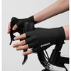 A hand wearing black Inbike half-finger cycling and MTB gloves is gripping a bicycle handlebar.
