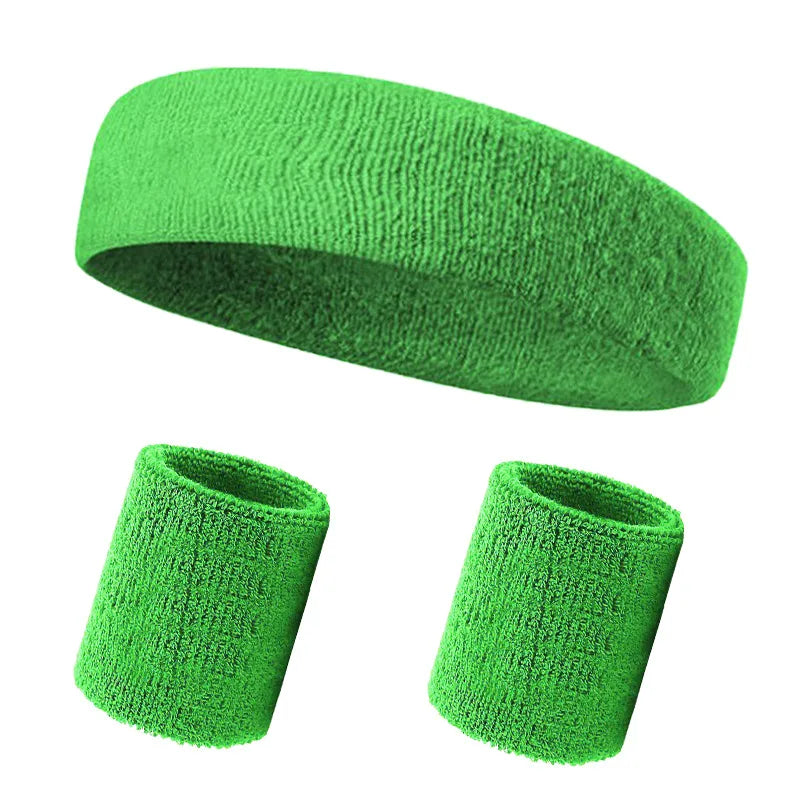 A green knitted sports headband shown in both a rolled and unfolded form.