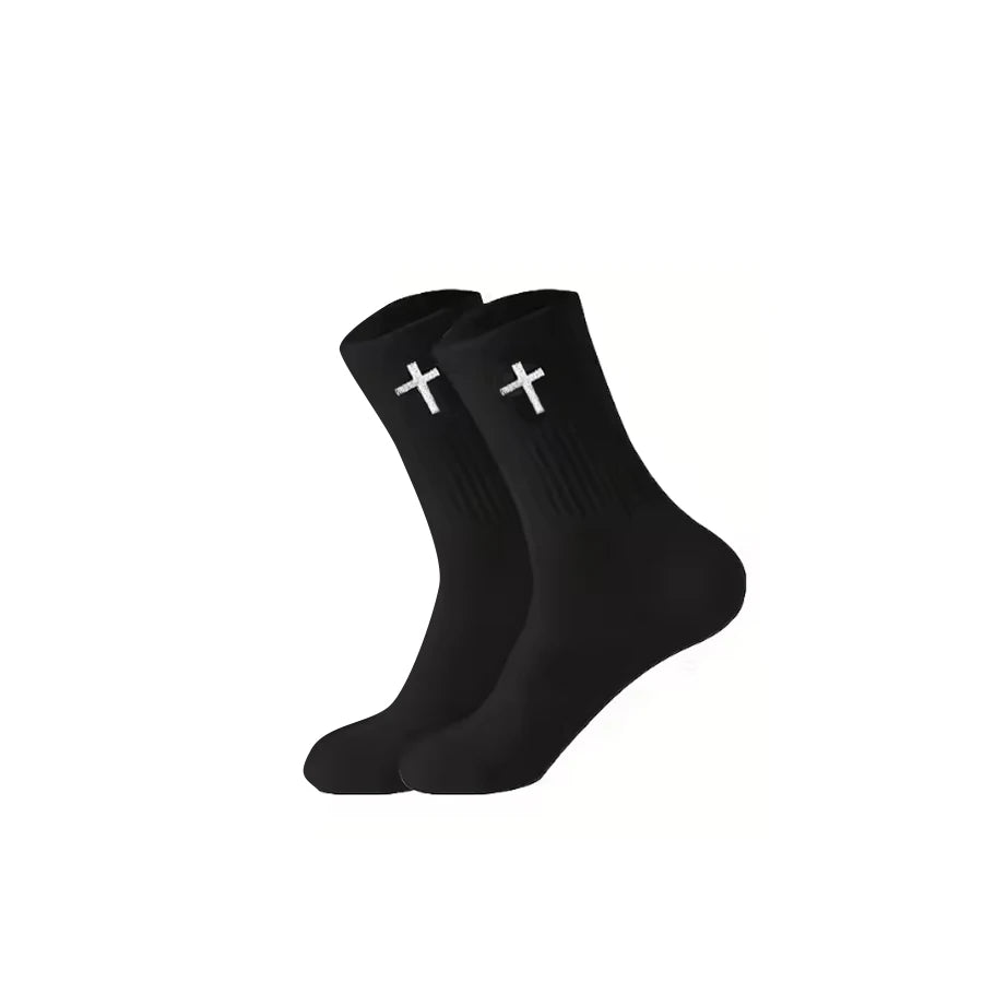 A pair of black knit mid-calf sports socks with white crosses on the toes.