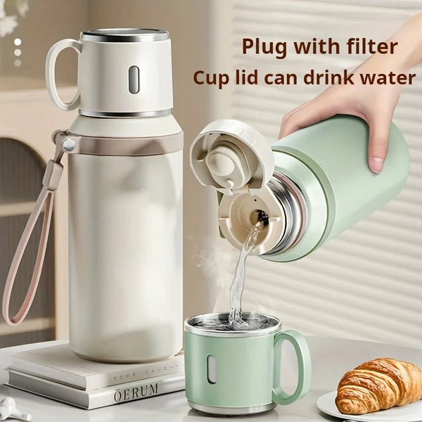 A hand is plugging a filter into an insulated stainless steel travel bottle to drink water.