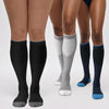 A pair of black compression socks worn on legs, showing the fit and texture.