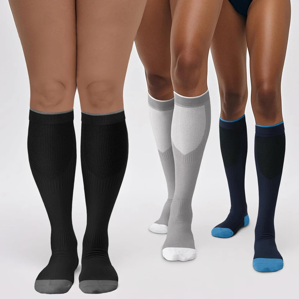 A pair of black compression socks worn on legs, showing the fit and texture.