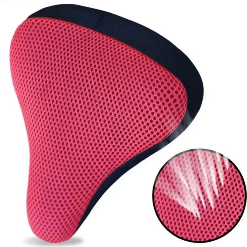 A bright pink and black breathable 3D mesh bicycle saddle cushion.