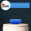 A blue silicone lid is shown being placed onto a light-colored bottle cap.