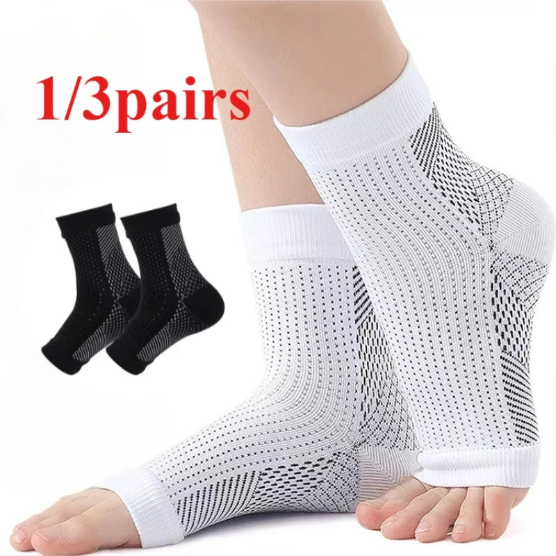 One pair of white compression ankle support braces shown on a foot and leg.