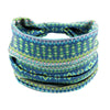 A colorful bohemian stretch cotton headband with geometric patterns in teal, green, and pink hues.