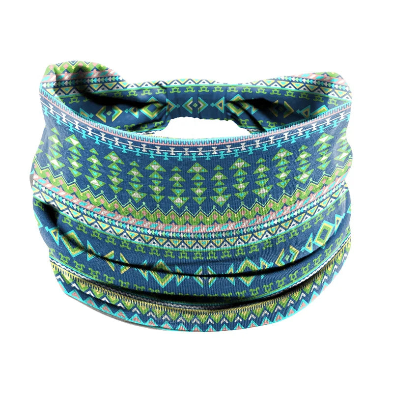 A colorful bohemian stretch cotton headband with geometric patterns in teal, green, and pink hues.