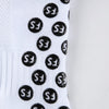 White athletic soccer socks with black anti-slip grip pattern on the calf.