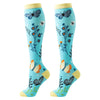 Pair of knee-high butterfly compression socks in blue with floral and butterfly patterns.