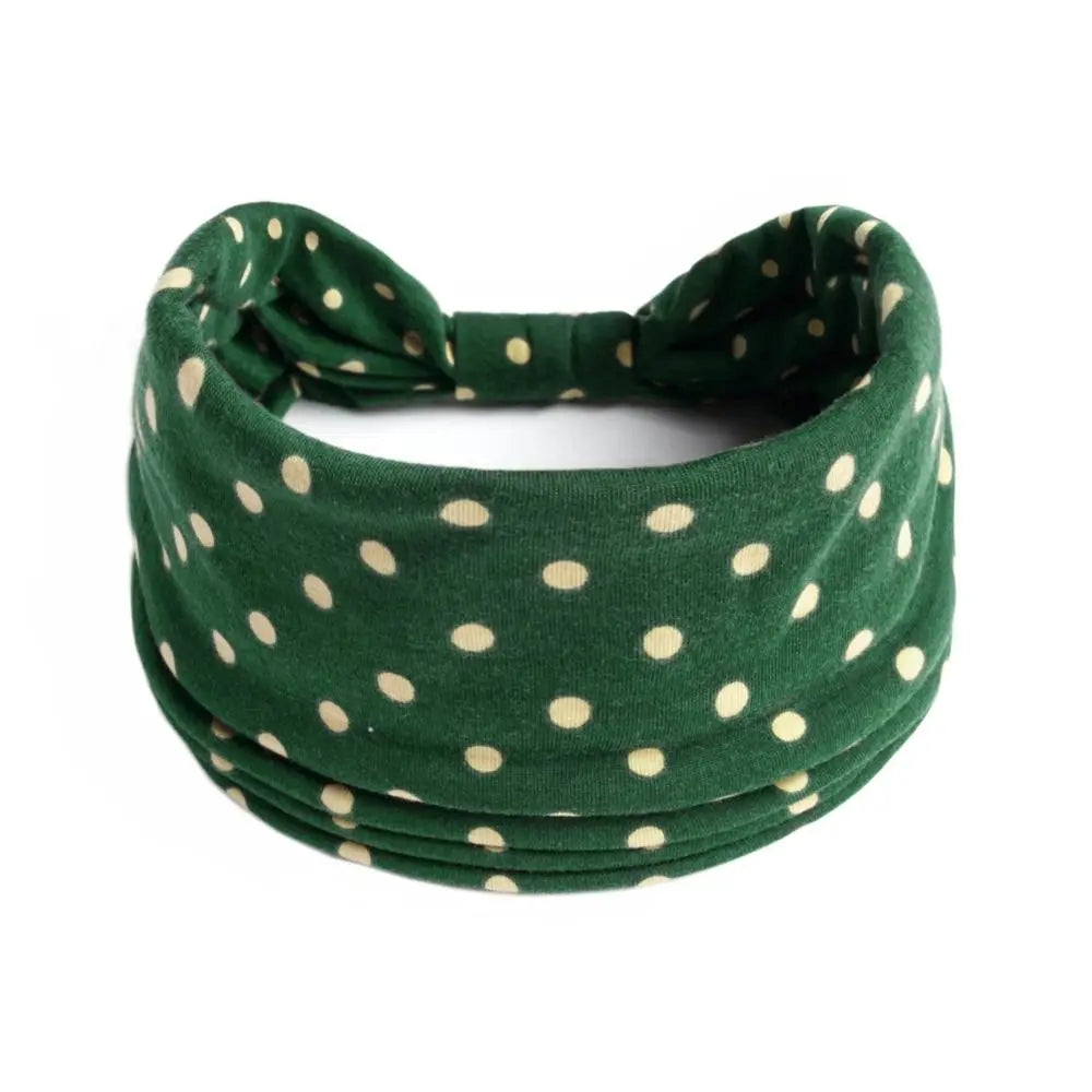 Goma para el pelo de algodón elástico bohemio verde oscuro atada en un lazo.