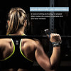 A person wearing black gym attire is using a black and silver weightlifting strap on their wrist.