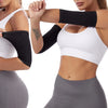 A woman wearing black slimming arm shaper sleeves and a white sports bra, posing for a fitness product photo.