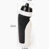 A white and black squeeze water bottle with a black cap, shown in a side profile.