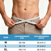 A person is measuring their waist circumference with a tape measure to determine sizing for an adjustable hernia belt.