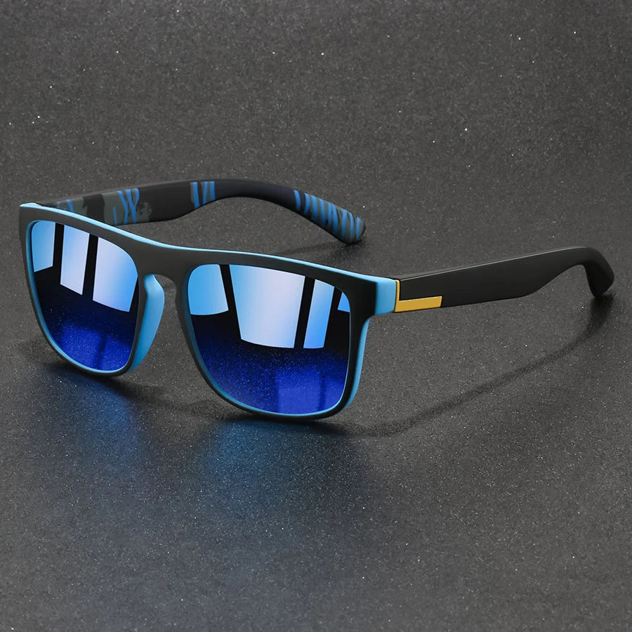 A pair of vintage designer square sunglasses with blue mirrored lenses and black frames resting on a dark surface.