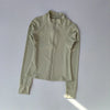 A light beige quick-dry yoga and fitness jacket shown flat lay.