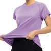 A woman wearing a purple quick dry moisture-wicking gym t-shirt and black pants.