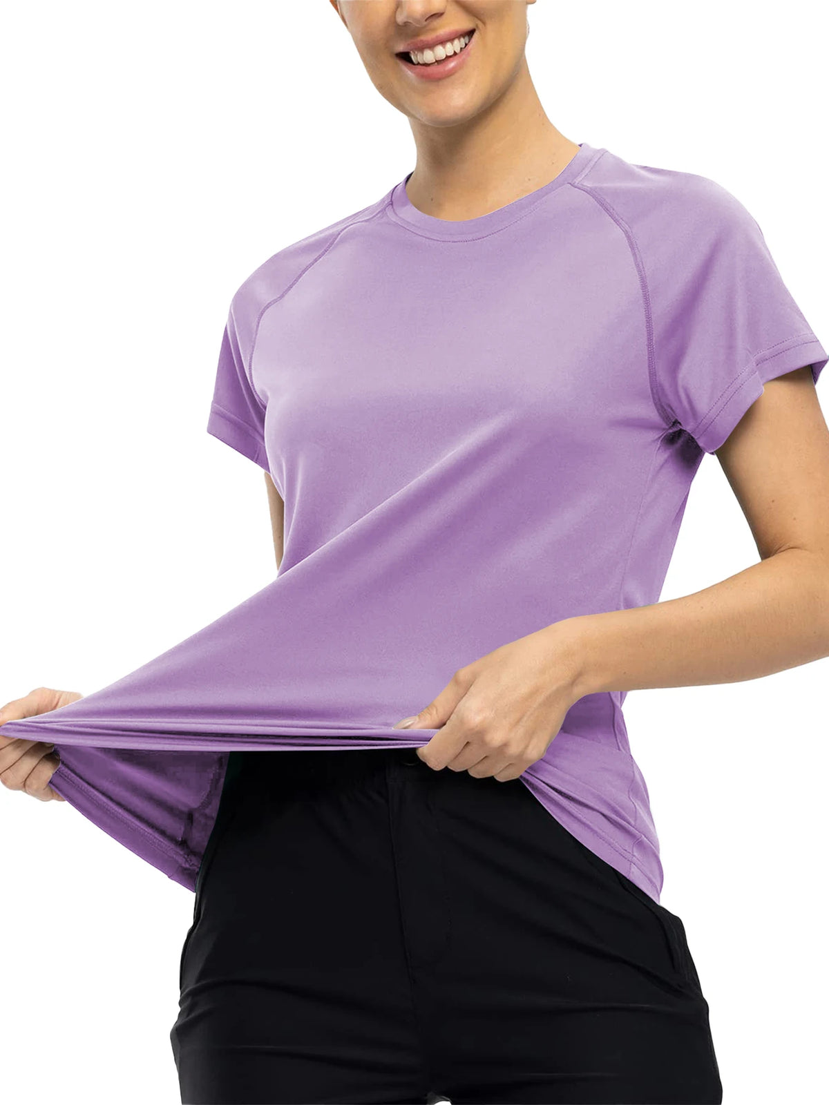 A woman wearing a purple quick dry moisture-wicking gym t-shirt and black pants.