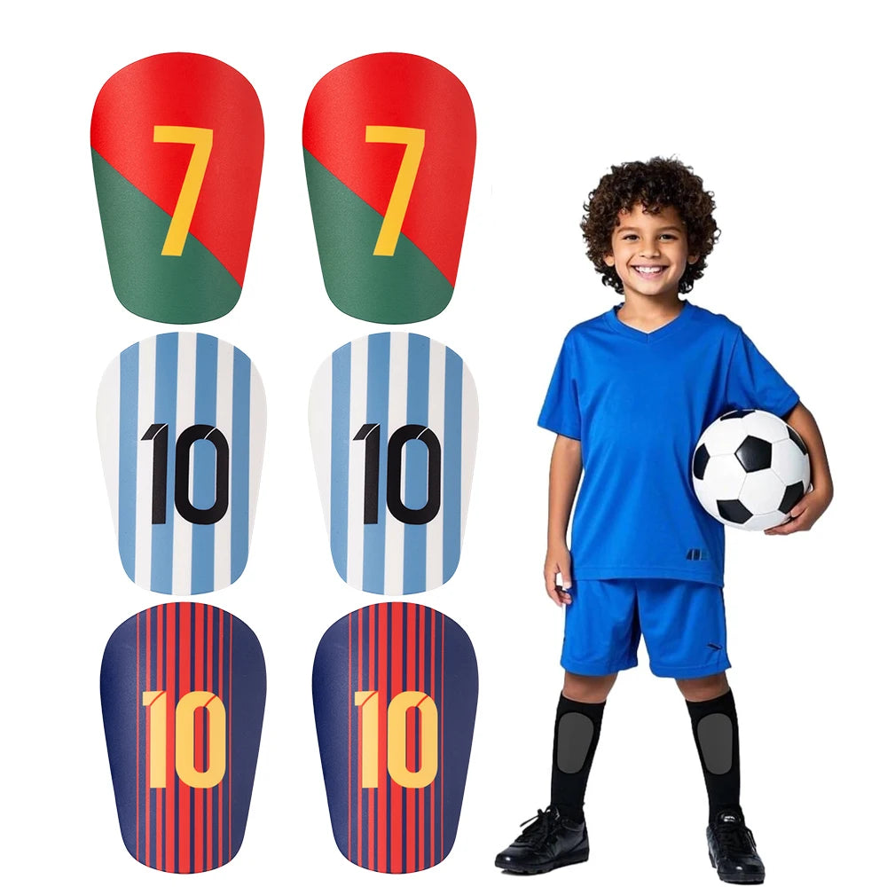 A boy wearing blue soccer gear, including a shirt and shorts, standing next to various colored shin guards.