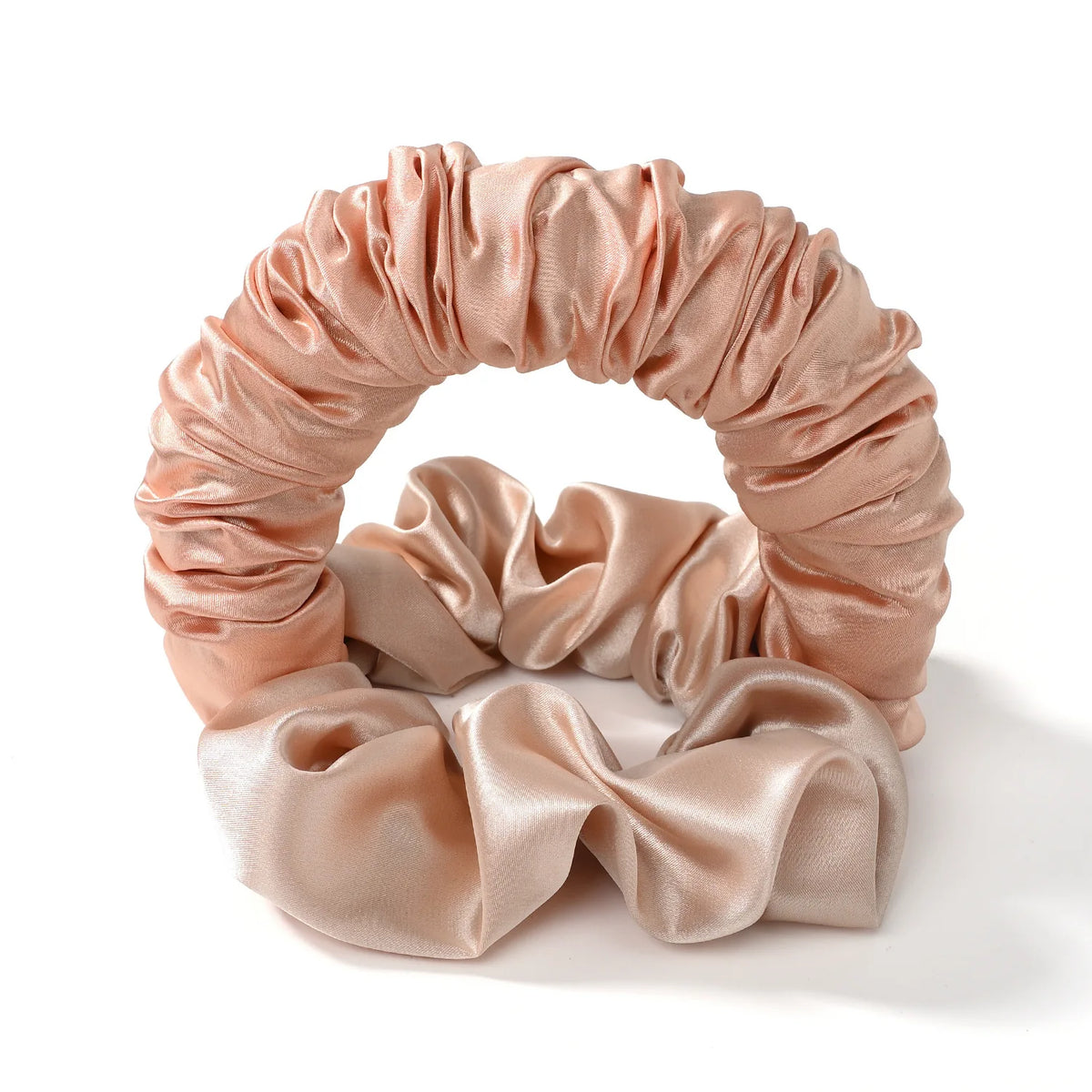 A pink satin heatless curling rod headband with gathered fabric curls.